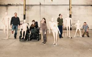 Group of people with visible physical disabilities posed next to mannequins designed to look exactly like them.