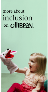 Image of light skinned girl with blond shoulder length hair , sitting on the floor and smiling at a puppet she has on her right hand. She is wearing a pink top and red pants anThe puppet is pink with black nose and eyes and red mouth and ears. The wall is light green and "more about inclusion on Ollibean " is written in dark grey.
